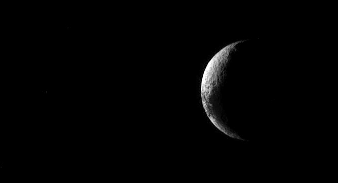 The sun shines on Iapetus' lighter surface