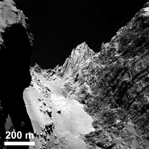 The boulder-strewn, smooth Hapi region in Comet 67P/Churyumov-Gerasimenko’s neck, with the Hathor cliff face to the right. Credits: ESA/Rosetta/MPS for OSIRIS Team MPS/UPD/LAM/IAA/SSO/INTA/UPM/DASP/IDA