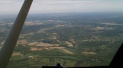 Aerial photo of the eroded Serpent Mound crater in Ohio. ("Serpent Mound Crater" by TTMR1986. Licensed under CC BY 3.0 via Wikimedia Commons.)