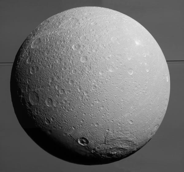 Mosaic of Saturn's 700-mile-wide moon Dione made from nine images acquired on Aug. 17, 2015. Saturn itself covers the entire background. (NASA/JPL/SSI)