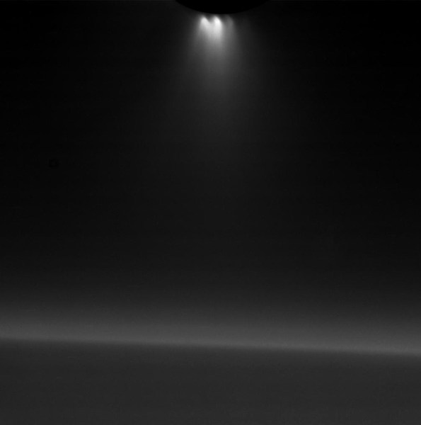 Narrow-angle image of Enceladus' backlit plumes shooting from its south pole. Saturn's nightside limb is in the background.