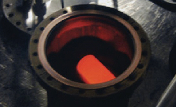 Plutonium dioxide glows with the heat of its natural decay inside a protective cylindrical shell of graphite. (DOE/Idaho National Laboratory)